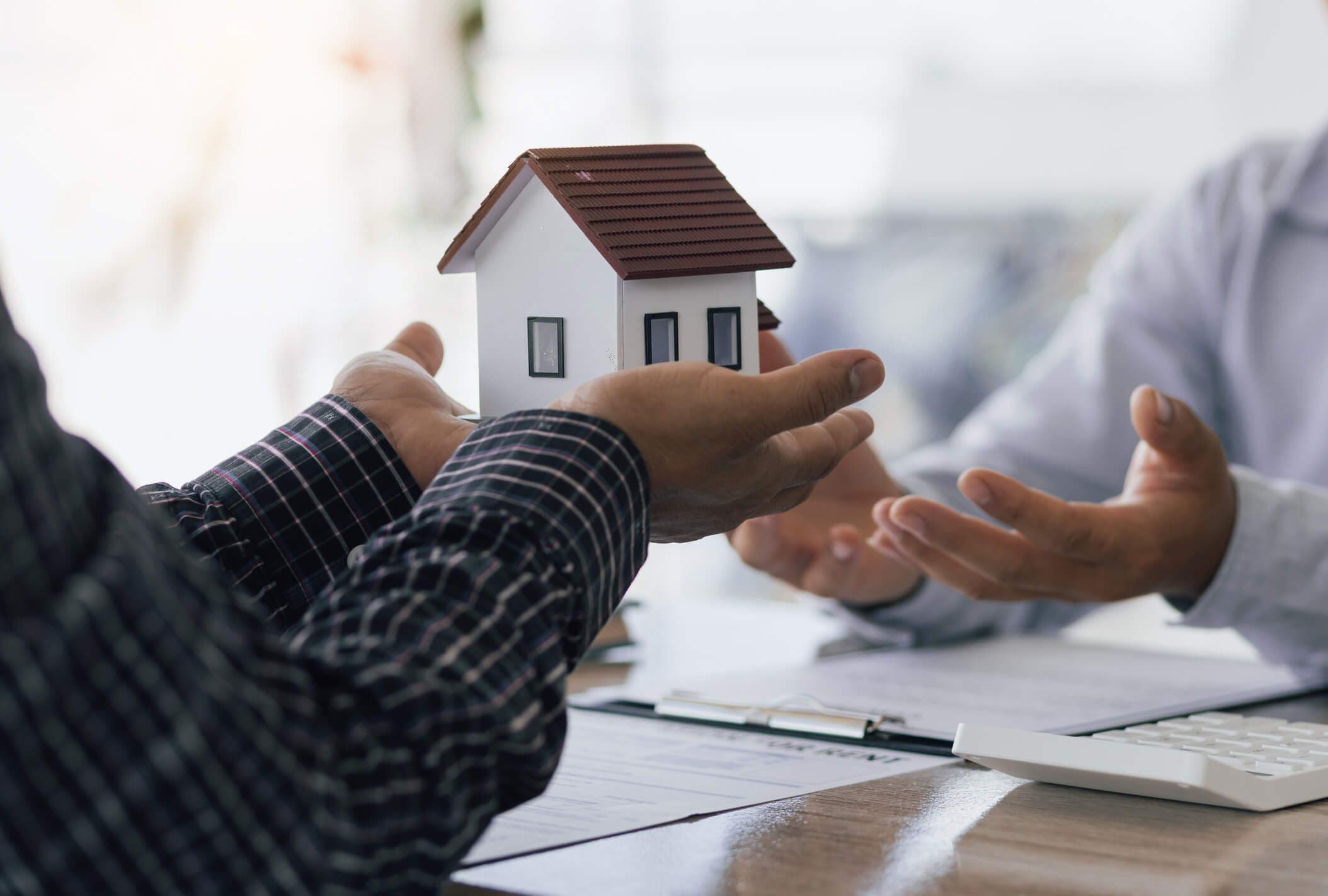 a mini house being handed off